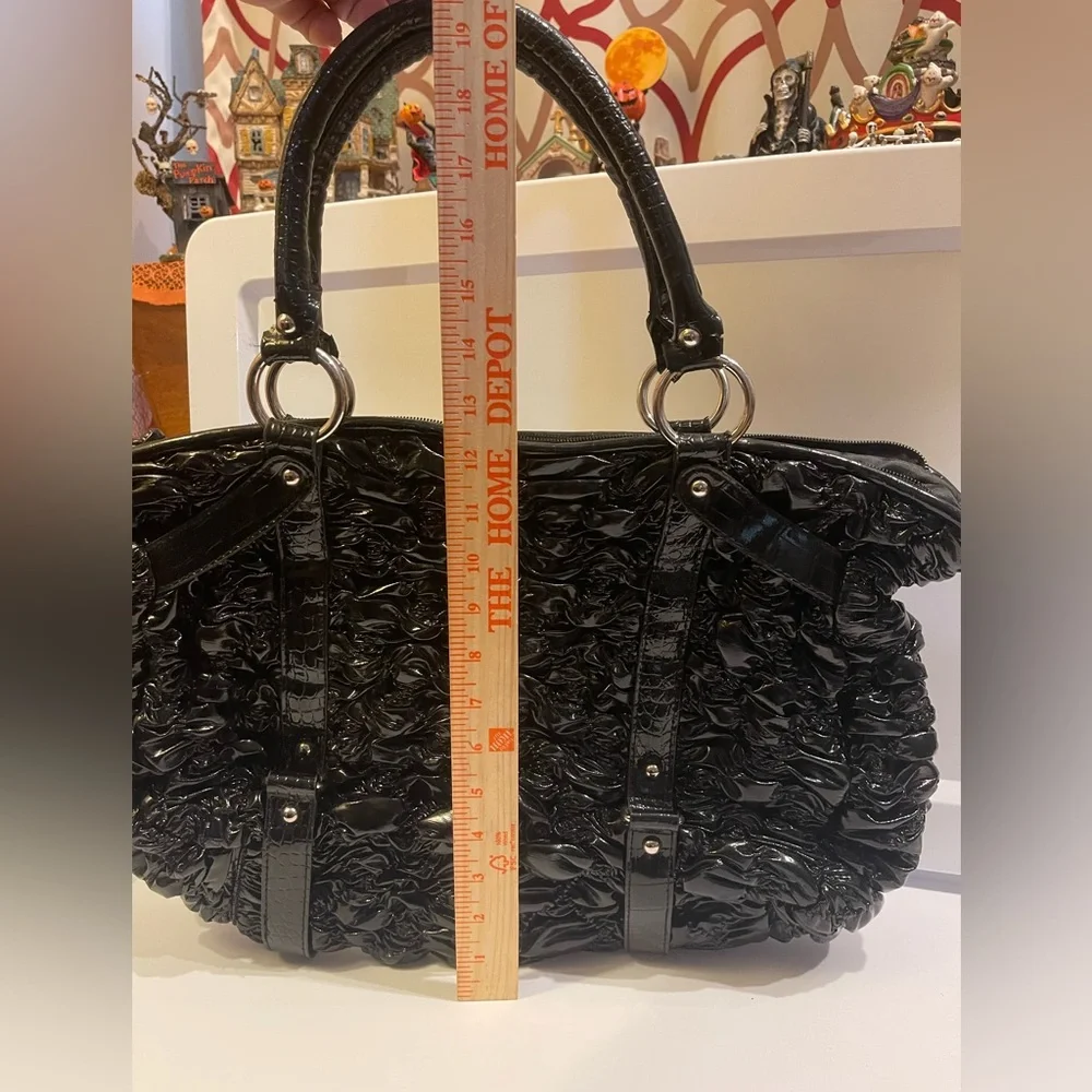 Woman’s black shiny ruffled tote handbag purse bag